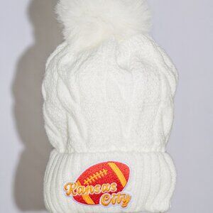 White stocking cap with K C Chiefs patches and fuzzy lining